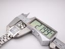 Digital caliper measuring the case diameter of the Tissot watch, displaying a precise measurement of 21.99mm.