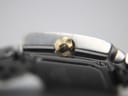 Macro close-up of the gold-tone crown of the Tissot T-Trend watch, showing its textured finish and embossed 'T' logo.