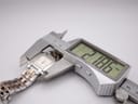 The Tissot T-Trend watch secured in a digital caliper, displaying a precise case width measurement of 21.86mm.
