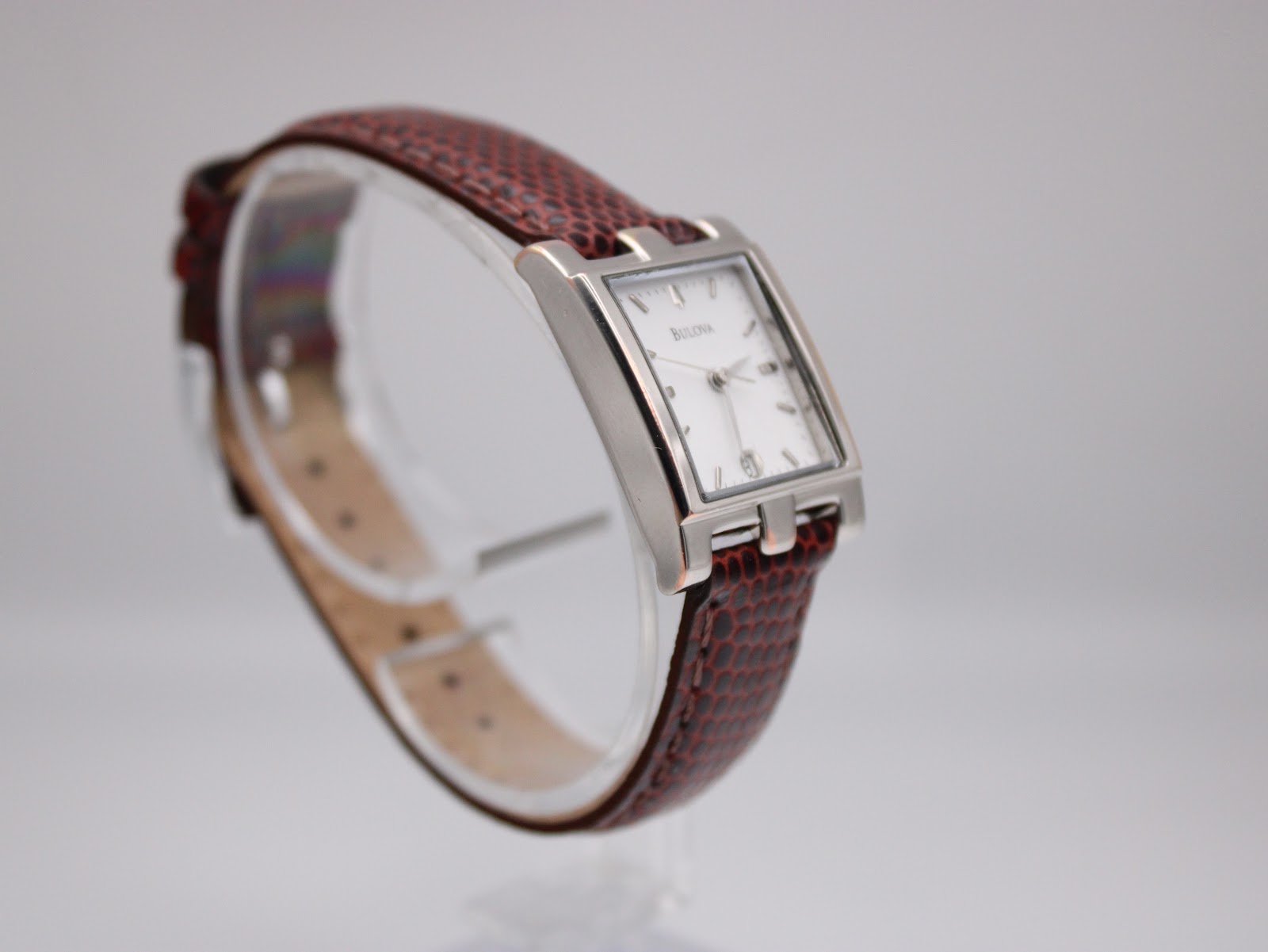 Another angled view of the watch on a display stand, highlighting the 'H-shape' lug design.