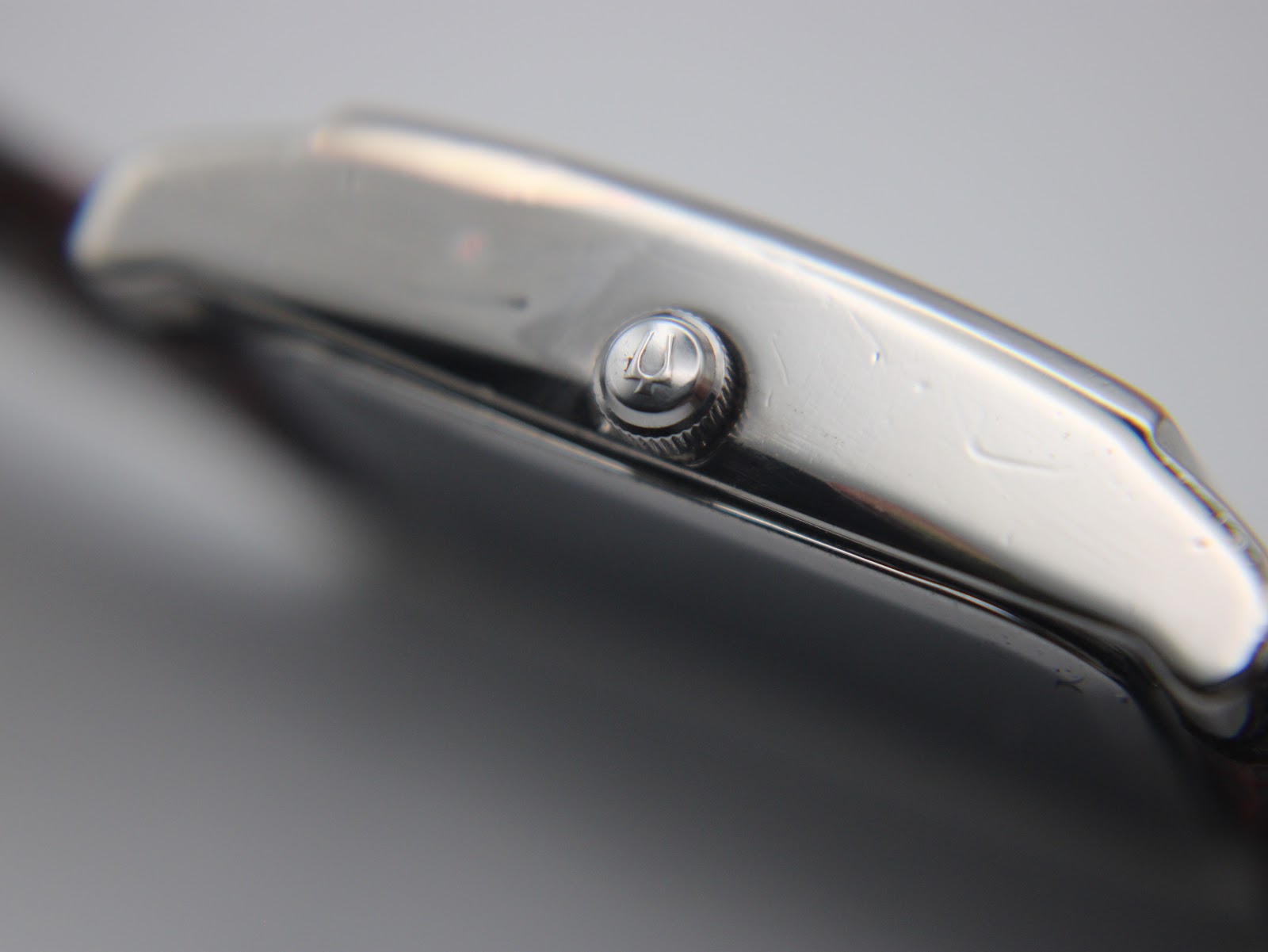Macro shot of the watch crown, featuring the embossed Bulova tuning fork logo.