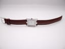 Overhead view of the Bulova watch with its burgundy lizard-grain leather strap extended flat.
