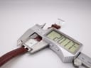Digital caliper measuring the Bulova watch case, displaying a precise width of 20.17mm.