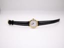 Top-down view of the Tissot C226K watch laid flat, displaying the gold case and the full length of the black croc-effect leather strap.