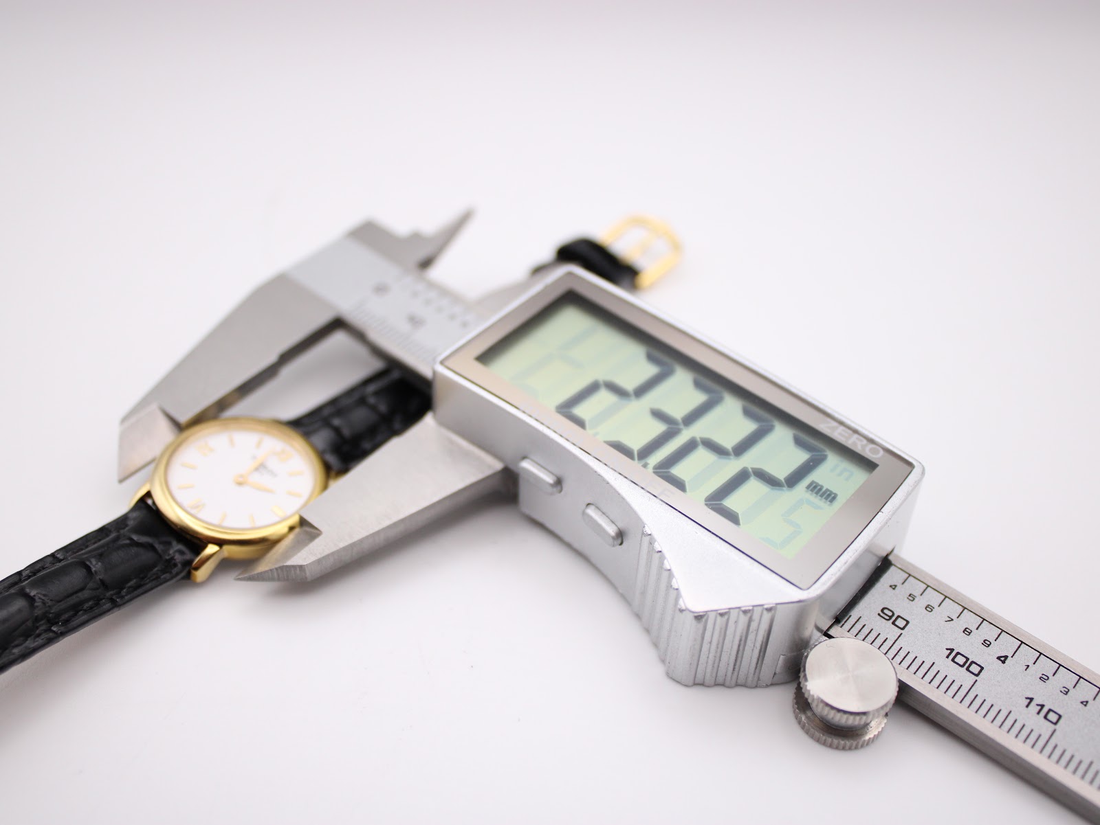 Digital caliper measuring the case diameter of the Tissot C226K watch, showing a precise reading of 22.22 mm.
