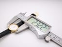 Digital caliper measuring the case diameter of the Tissot C226K watch, showing a precise reading of 22.22 mm.