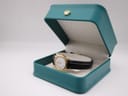 The Tissot C226K watch displayed open in a teal-coloured presentation box with a gold crown emblem on the lid.