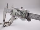 Digital caliper measuring the case diameter of the Gucci 134.5 watch, displaying an exact measurement of 26.96mm.