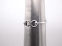 The Gucci watch bracelet wrapped around a metal wrist sizing cone, indicating a wrist circumference of approximately 16.5cm.