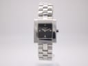 Front view of the Tissot L730K ladies' quartz watch with a square black dial and integrated stainless steel bracelet.