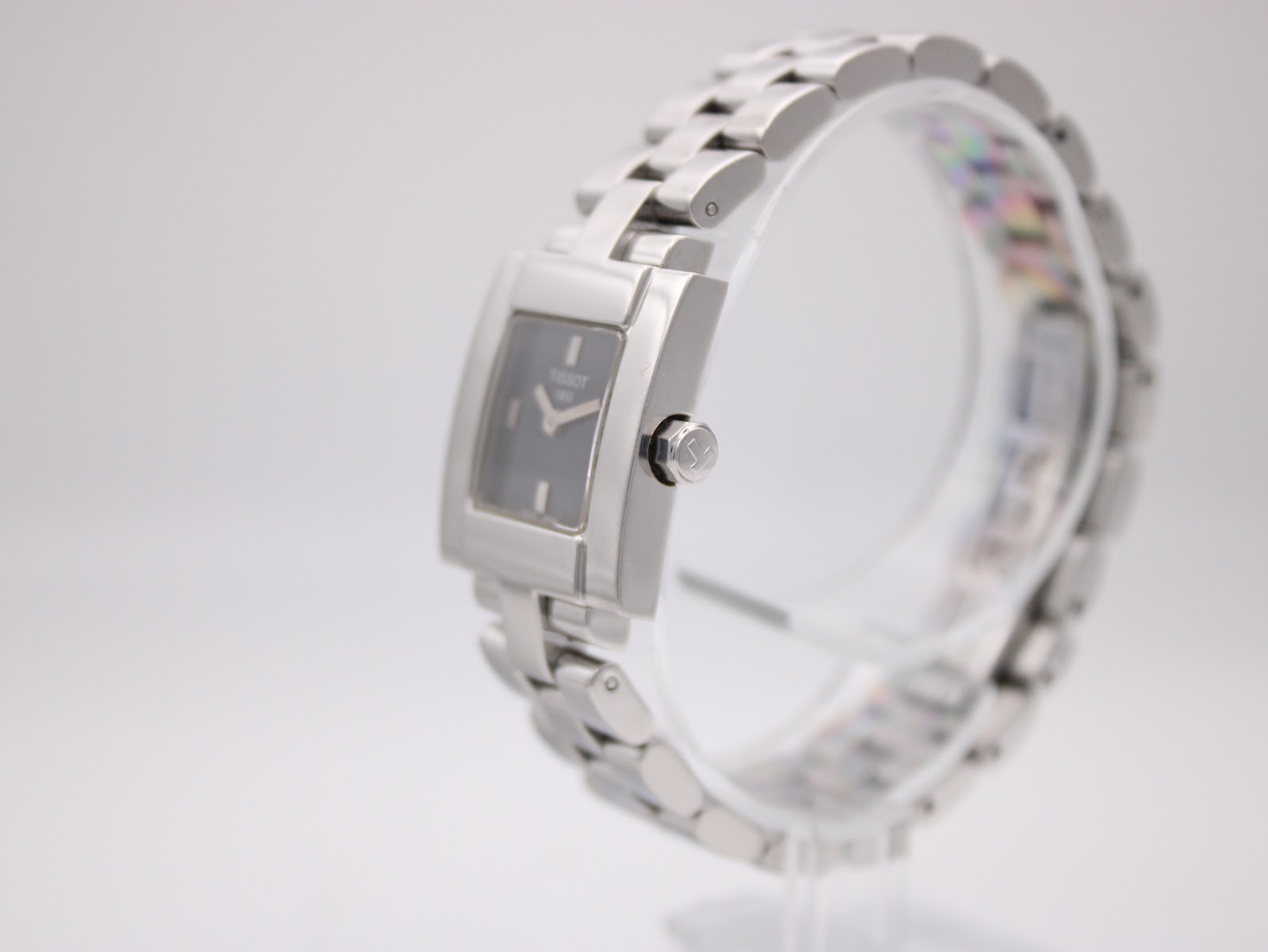 Angled view of the Tissot L730K showing the polished stainless steel case and crown with Tissot logo.