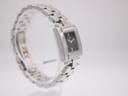 Side view of the Tissot L730K watch on a clear display stand, highlighting the integrated bracelet design.