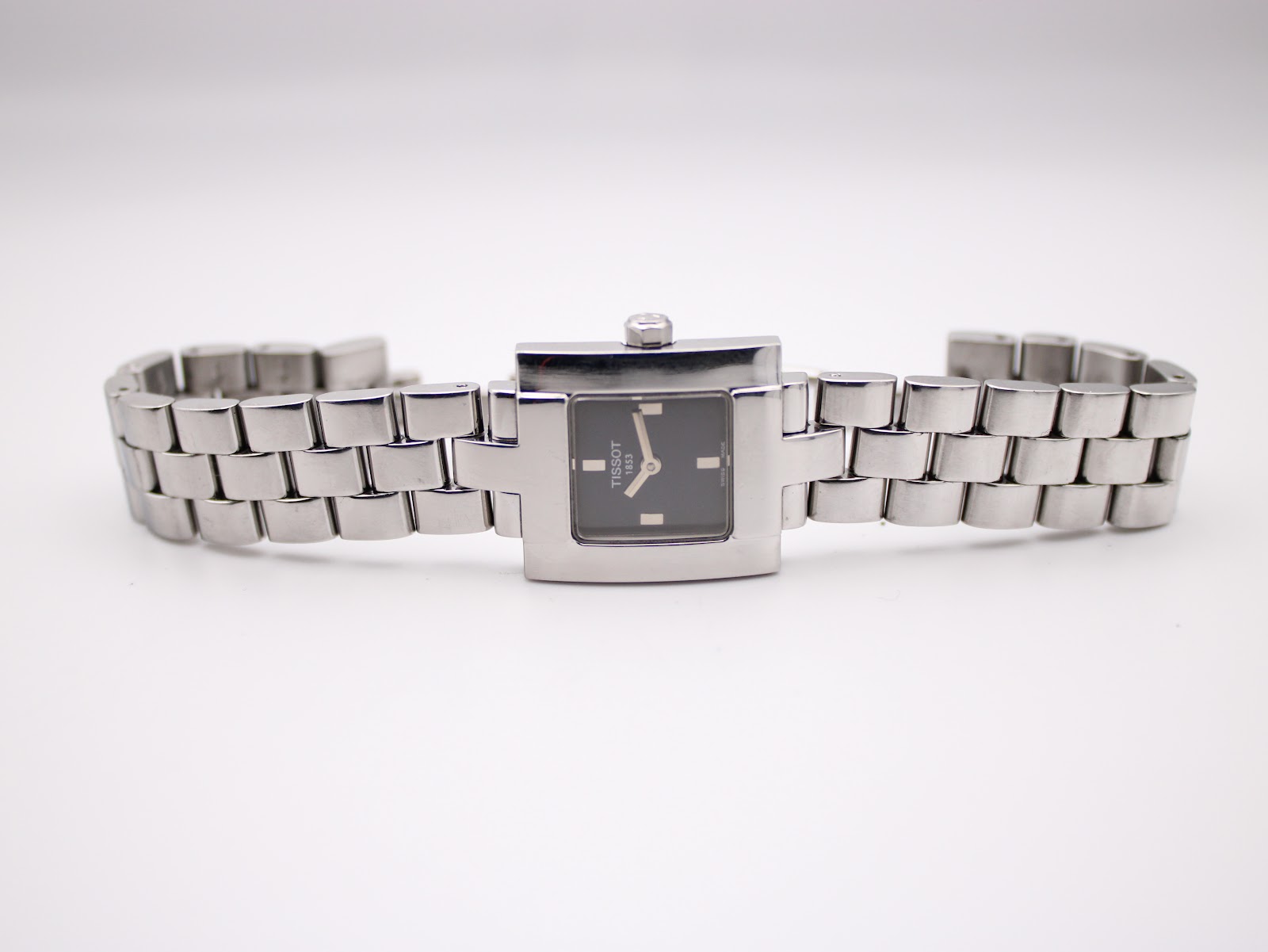Overhead view of the Tissot L730K watch with its integrated multi-link bracelet laid flat.