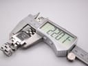 Digital caliper measuring the width of the Tissot L730K watch case, showing a precise measurement of 22.07mm.