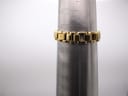 Close-up of the gold-tone Tissot bracelet wrapped around a watch sizing cone, indicating a wrist circumference measurement of approximately 138mm.