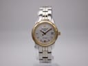 Front view of a Tissot PR 100 ladies' watch with a silver sunburst dial and two-tone stainless steel and gold PVD bracelet.