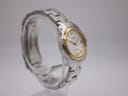 Another angled side view of the Tissot PR 100 watch, highlighting the gold PVD crown and the elegant case profile.