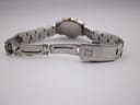 Close-up of the brushed two-tone stainless steel bracelet clasp, featuring the embossed Tissot logo.