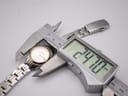 Digital caliper measuring the watch case diameter, showing a precise measurement of 24.70mm.