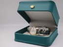 The Tissot PR 100 watch nestled inside an open green London Watch Market presentation box.