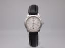 Front view of Tissot J326426 women's quartz watch with silver dial, Arabic numerals, and black leather strap.