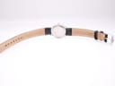 Full back view of the Tissot watch with its black leather strap extended, showing the case back and the strap's lining.