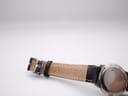Close-up of the black leather strap's lining and the signed Tissot stainless steel buckle.