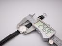 Digital caliper measuring the case diameter of the Tissot watch at 24.69mm.