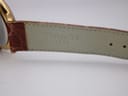 Close-up of the interior of the brown leather strap, showing the embossed "TISSOT 1853" branding near the lugs.