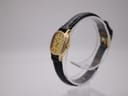 Side profile of Tissot cushion case, showing crown and strap.