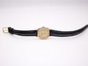 Detail of black croc-effect genuine leather watch strap.