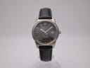 Front view of Tissot PR 100 Titanium watch with grey dial and black leather strap.