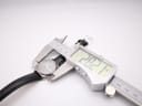 Digital caliper measuring the case diameter of the Tissot watch at precisely 28.21mm.