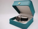 Tissot PR 100 watch presented in an open teal London Watch Market presentation box.