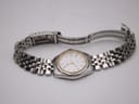 Overhead view of the Tissot watch laid flat with its two-tone bracelet unclasped, showing the full length of the bracelet and the signed deployant clasp.