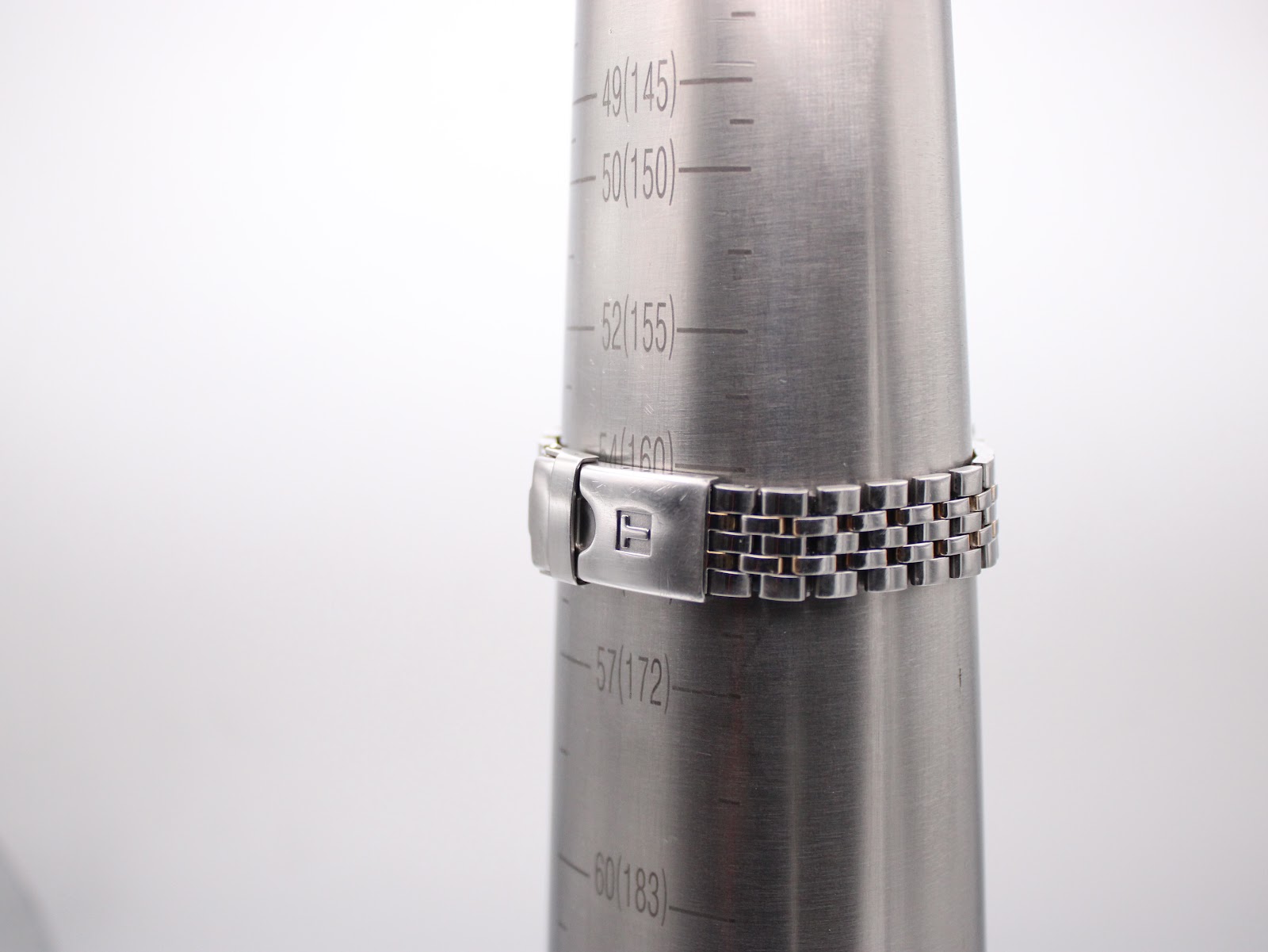 Side view of the watch bracelet clasped around a wrist sizing cone, indicating a wrist circumference of 160mm / 16cm.
