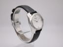 Another angled side view of the Tissot T023210A watch, showcasing the polished stainless steel case and curved lugs.