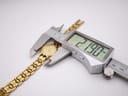 A digital caliper measuring the case diameter of the Tissot E421K at 21.90mm.
