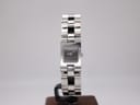 Front view of Gucci 2300L watch with rectangular polished stainless steel case and dark grey dial on a stand.