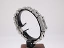Angled side view of the Gucci 2300L on a stand, highlighting the bracelet construction and case design.
