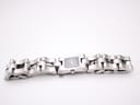 Angled top view of the Gucci 2300L watch with its stainless steel link bracelet laid out, showing the case and bracelet details.