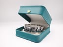 The Gucci 2300L watch presented inside a non-original teal presentation box.