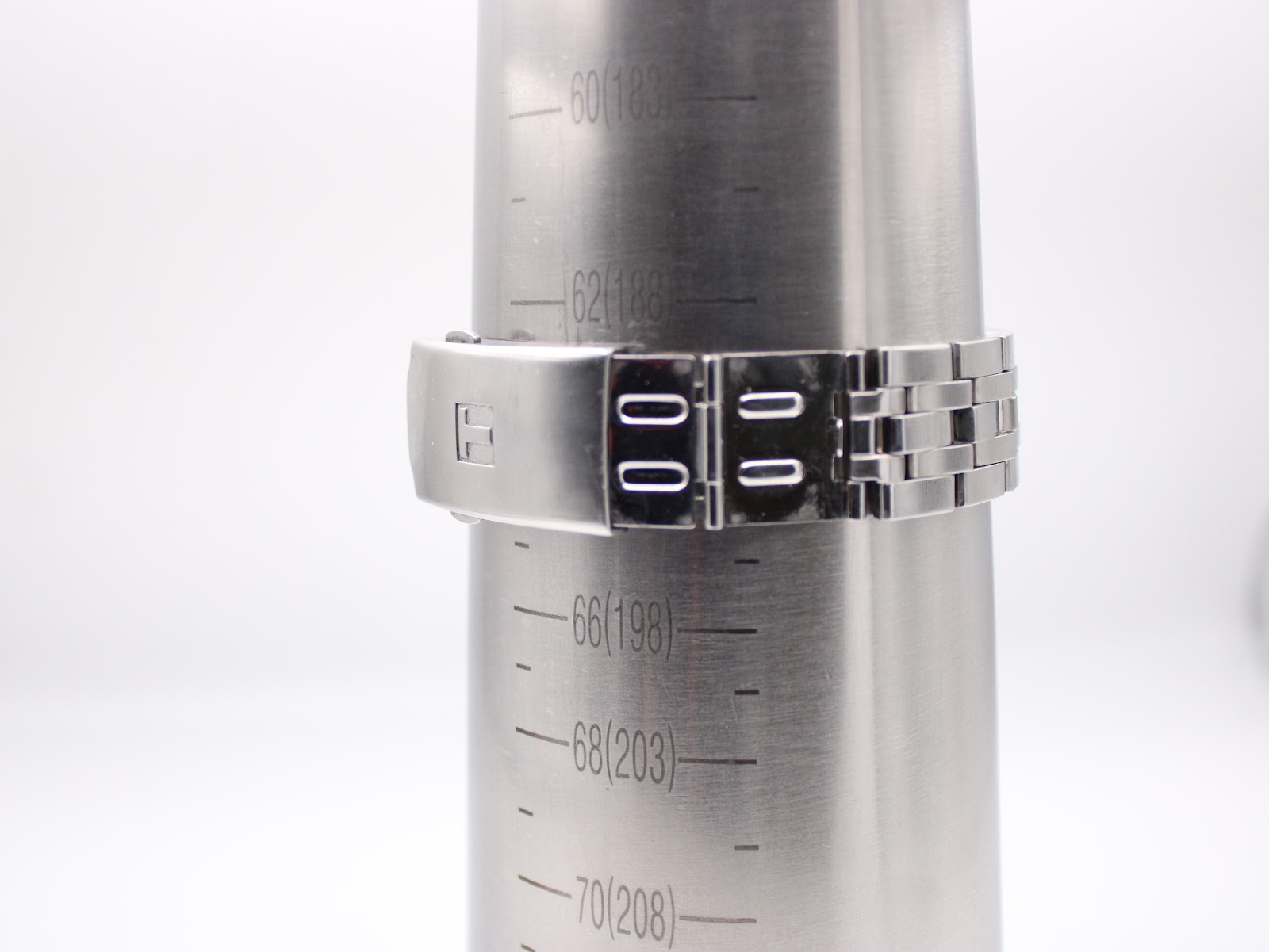 Tissot bracelet on a wrist sizing gauge, showing the maximum circumference with the diver's extension deployed, reaching approximately 198mm.