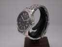 Angled side view of the Tissot PRC 200 watch, highlighting the polished and brushed stainless steel case and crown.