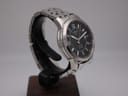 Another angled side view of the Tissot PRC 200 watch, showcasing the case profile and bracelet links.