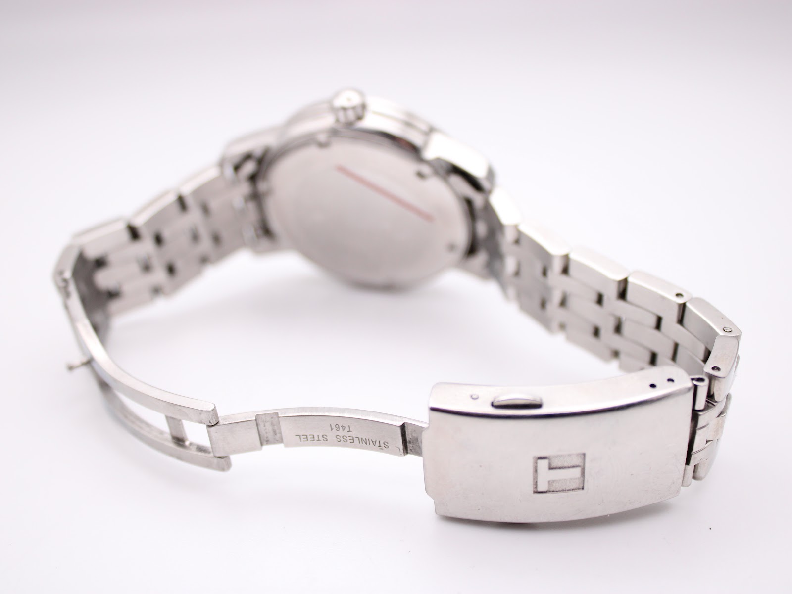 Interior view of the Tissot stainless steel bracelet and fold-over clasp, showing its construction and 'STAINLESS STEEL' engraving.