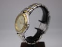 Side view of the Citizen two-tone watch showing the gold-tone crown and integrated bracelet.