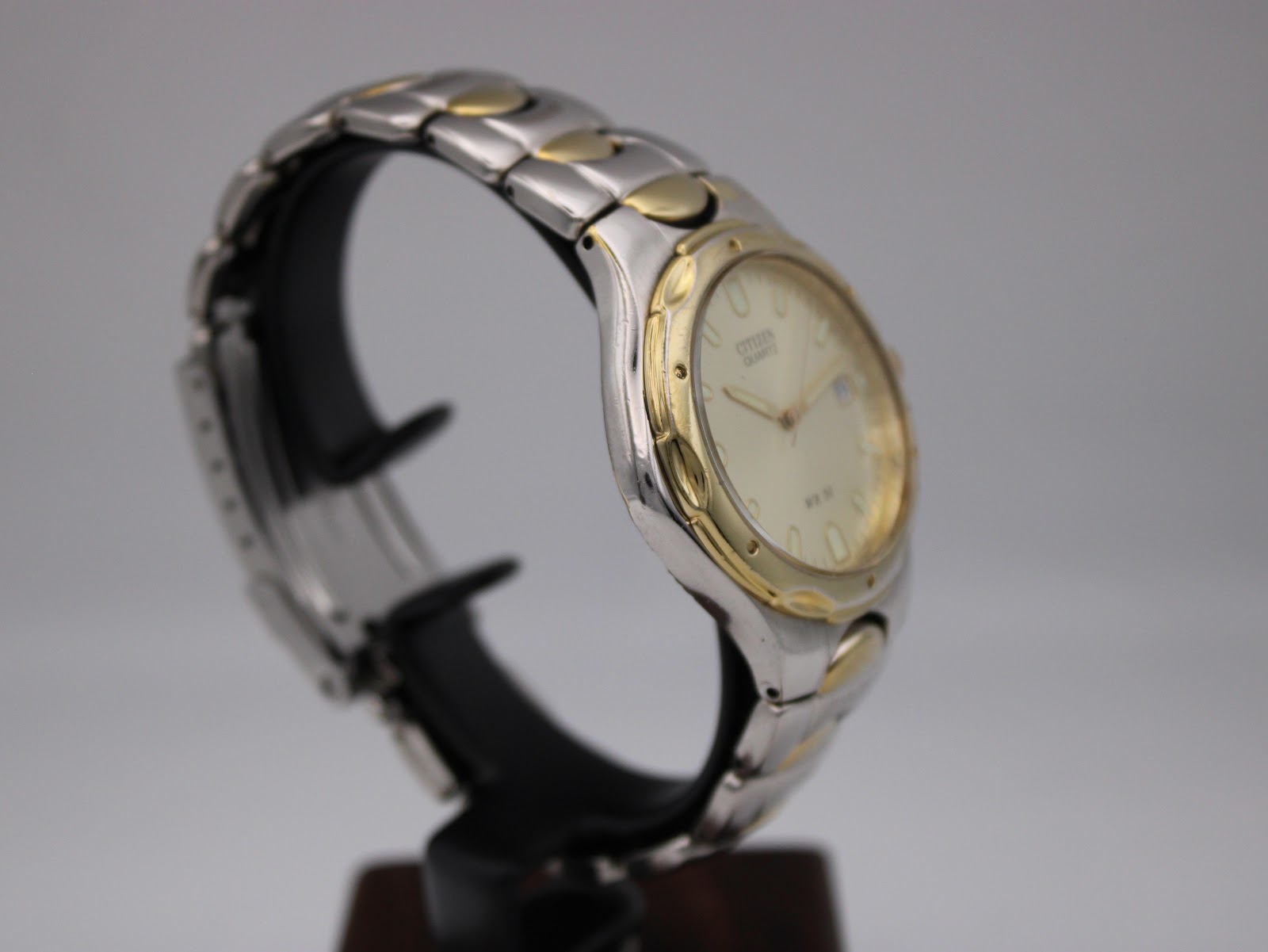 Another side view of the Citizen two-tone watch, highlighting the case profile and bracelet links.