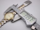 Digital caliper measuring the watch case diameter at 39.97mm, with the two-tone bracelet visible.