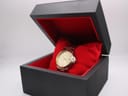 The Citizen watch presented inside an open black box with a red cushion interior.